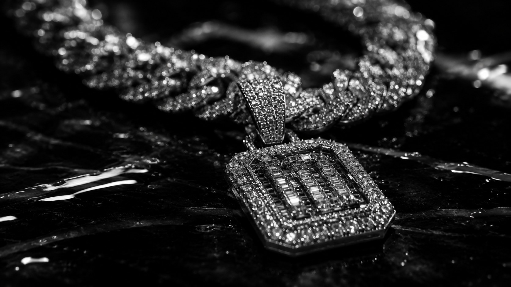 Black and white product photograph of a diamond chain pendant