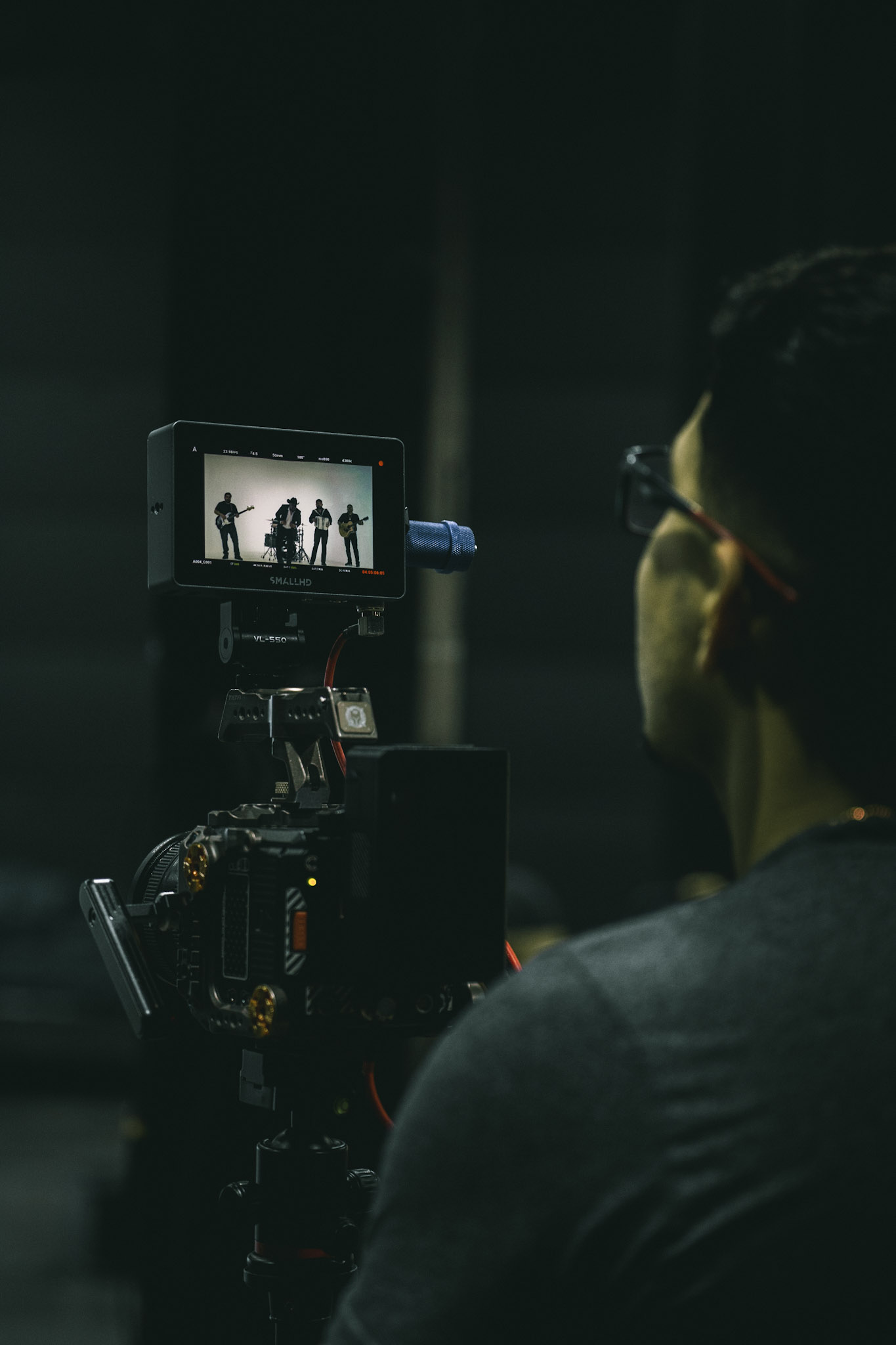 Camera operator monitoring a band on a SmallHD field monitor during a music video shoot